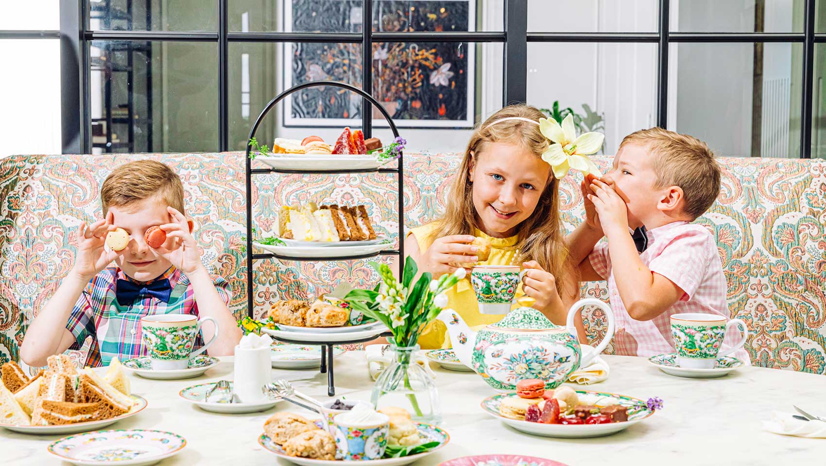 children enjoying tea snacks at a table at Fontenelle Tea Room at Kimpton Cottonwood Hotel