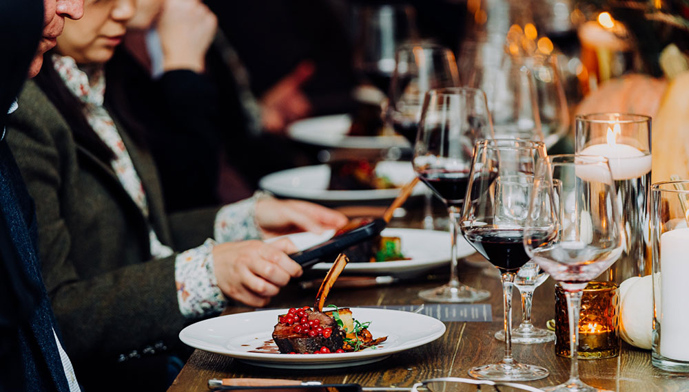 people sharing a long table dinner