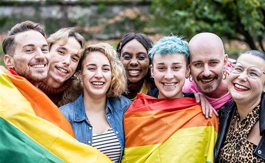 people in front of pride flag