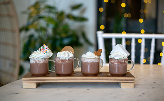 a flight of 4 hot chocolate mugs