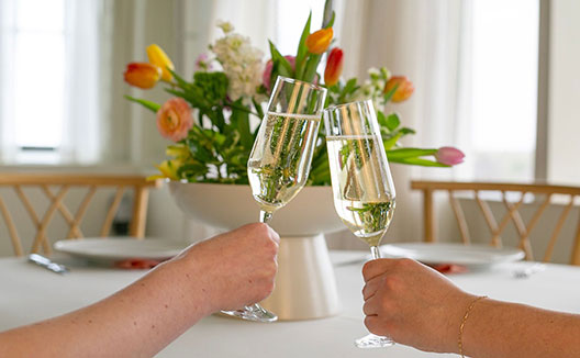 two women with two glasses of sparking wine